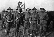 Karl Linderfelt, center. Photo caption reads: "Officers of the Colorado National Guard. From left to right: Captain R. J. Linderfelt, Lieut. T. C. Linderfelt, Lieut. K. E. Linderfelt, (who faced the charge of assault upon Louis Tikas, the dead strike leader), Lieut. G.S. Lawrence and Major Patrick Hamrock. The last three were in the Ludlow battle of April 20, 1914."