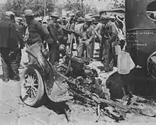 the almost destroyed chassis of Kehoe's Ford pickup truck, surrounded by onlookers