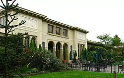 Photograph of a multi-arched entry to a large, single-story building.