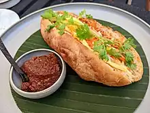 Khao chī pate in Laos, with spice paste on the side