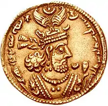 A gold coin with head of Khosrow II facing right surrounded by Middle Persian writing