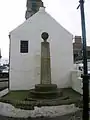 The Mercat cross at the 'jougs.'