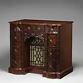 Kneehole writing table; circa 1760; mahogany, mahogany veneer and gilt bronze; 88.9 × 97.8 × 62.2 cm; Metropolitan Museum of Art (New York City)