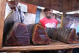 thick, dark brown rolls of peanut pâté wrapped in banana leaves