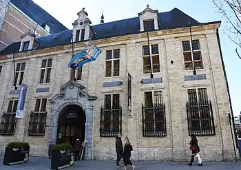 A yellow brick building with a blue roof.