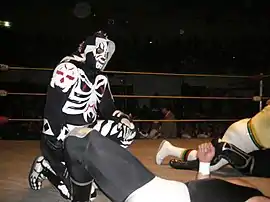 A masked wrestler wearing a full body suit that makes him look like a skeleton/