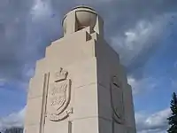 One of the memorial's four corner pillars, with coats of arms for Wales and England.