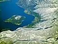 Aerial view of Monte Isola (both Montisola island, Loreto isle and San Paolo isle) and part of the Brescia shore of the Iseo lake in winter