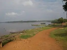 A large lake with a path on the foreshore