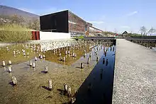 The Laténium building; the bassin of the foreground represents the level of the lake 15 000 years ago, with the pilotis of the neolithic.