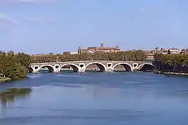 Arched bridge crossing a broad river