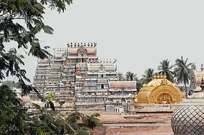 Image 25The golden Vimana over the sanctum at Srirangam midst its gopurams, its gable with Paravasudeva image. (from Tamils)