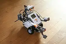 A small robot on a floor