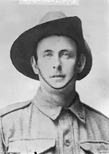 A slightly grainy head and shoulders portrait of a man in military uniform wearing a slouch hat. He is looking at the camera.