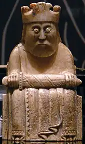 Photograph of an ivory gaming piece depicting a seated king