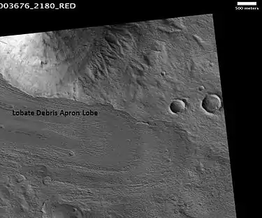 Lobate debris apron in Phlegra Montes, as seen by HiRISE.  The debris apron is probably mostly ice with a thin covering of rock debris, so it could be a useful source of water.  Scale bar is 500 meters long.