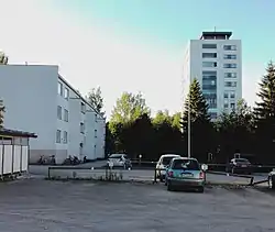 An apartment building built in the 1960s and a tower block built in 2012.