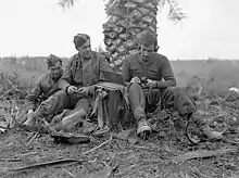 Infantrymen of The Loyal Edmonton Regiment operating a No. 18 wireless set outside Regimental Headquarters, Ortona, Italy, December 21, 1943