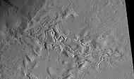 Surface features of Lycus Sulci, as seen by HiRISE under the HiWish program.