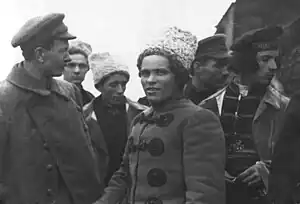 Nestor Makhno and Fedir Shchus standing together with other Makhnovists in front of a train