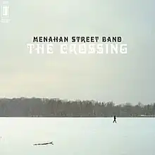 A photo of a man walking across a snowy field