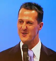 A man in his late thirties speaking into a microphone