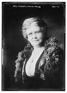 An older white woman with white hair, wearing eyeglasses.