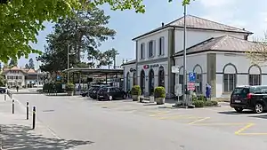 Two-story building with hip roof and single-story wings