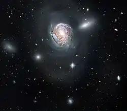 A face-on view of a spiral galaxy (NGC 4911) located deep within the Coma Cluster.