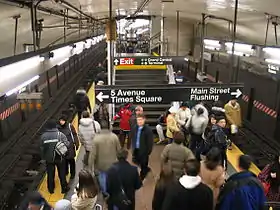 Looking down a staircase toward the IRT Flushing Line platform