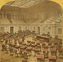 One panel of a stereographic view of the Senate in the 19th century; hand-colored image shows desks, dais, and gallery above