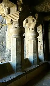 Cave No.3 pillars (back view). They have no base, and "stand on a bench in the veranda, and in front of them is a carved screen".