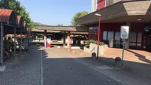 Asphalt sidewalk leading to canopy-covered platforms