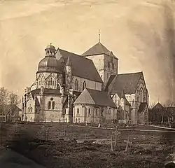 Tinted photo of Nidaros Cathedral behind its churchyard