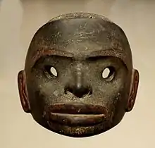 A dark stone mask, free standing