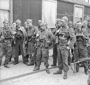 A group of 15 men in uniform carrying weapons