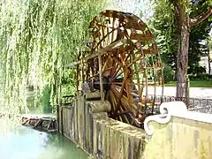 Noria in Tomar, Portugal. Paired ceramic pots along the wheel collect the water.