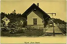 A postcard photo of a small railroad station