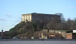 The Castle high on its promontory above nearby rooftops against a bright blue winter sky