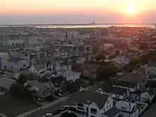 A view over a town early in the morning with a power plant smokestack in the background