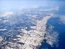 Aerial view of Ōmu (at bottom edge of picture) with Esashi in the distance