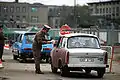 An East German policeman monitors traffic returning to East Berlin through the newly created opening in the Berlin Wall at Potsdamer Platz on 14 November 1989.