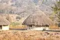 A traditional tribal house at the border of the protected forest