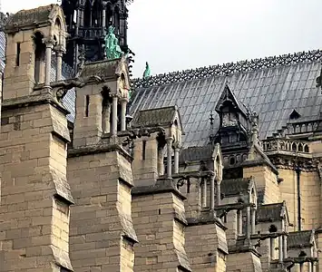 The massive buttresses which counter the outward thrust from the rib vaults of the nave. The weight of the building-shaped pinnacles helps keep the line of thrust safely within the buttresses.