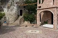 View of the cave entrance (left) and the main church (right)