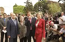 Vladimir Putin, Paul McCartney, and Heather Mills surrounded by reporters and photographers.