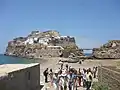 Peñón de Vélez de la Gomera; the border runs along the grey sand spit where the boats are laid