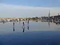 The Miroir d'eau, the Pont de pierre and the Basilica of St. Michael.