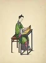 Woman playing what looks like a yangqin or some sort of psaltery-like instrument.