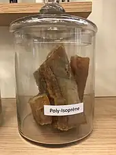 Pieces of polyisoprene in a jar